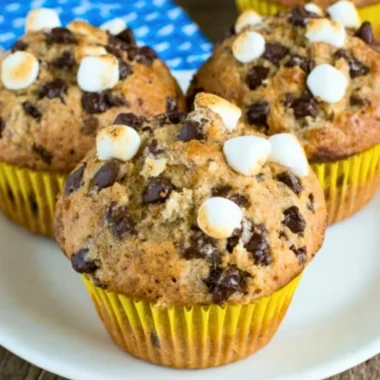 Delicious Banana S'mores Muffins topped with chocolate and marshmallows