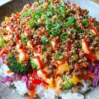 Bang Bang Ground Turkey Rice Bowl topped with vegetables and sauce