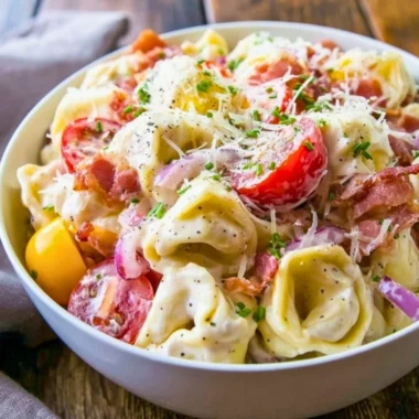 Delicious and colorful grinder tortellini salad with fresh vegetables and dressing