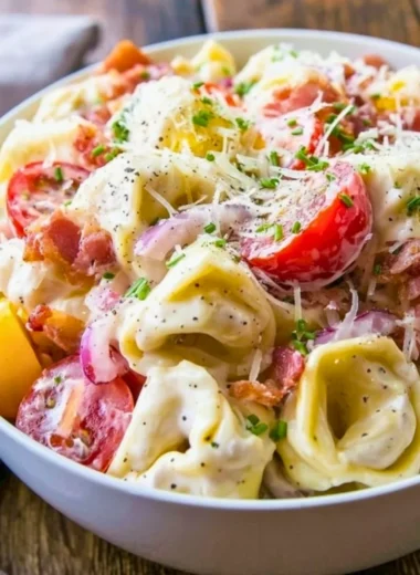 Delicious and colorful grinder tortellini salad with fresh vegetables and dressing
