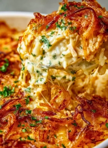Creamy French Onion Chicken Rice dish garnished with herbs and served in a bowl