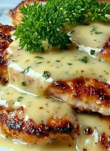 Plate of crispy Malibu chicken with tropical garnish and side dishes.