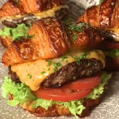 Delicious croissant smash burgers with juicy patties and toppings
