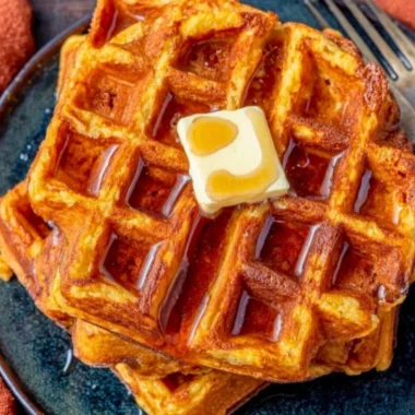 Delicious French Toast Waffles served with syrup and berries