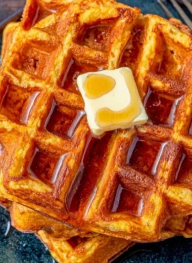 Delicious French Toast Waffles served with syrup and berries