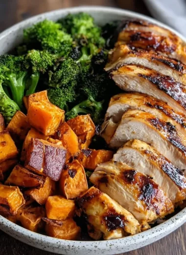 Delicious grilled chicken and sweet potato bowl garnished with fresh herbs