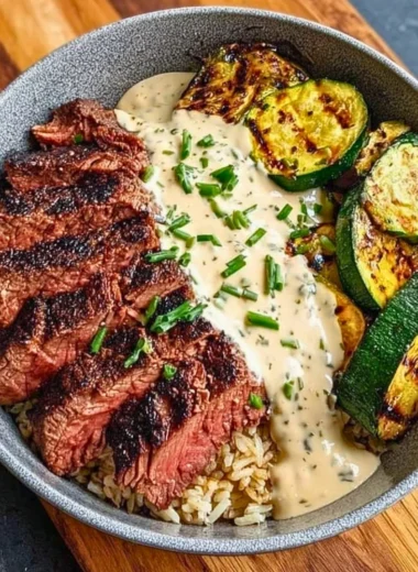 Grilled steak bowl with sauce and grilled zucchini on a plate
