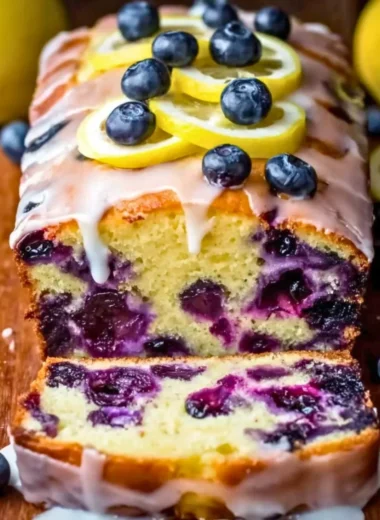 Homemade blueberry yogurt in a bowl topped with fresh blueberries