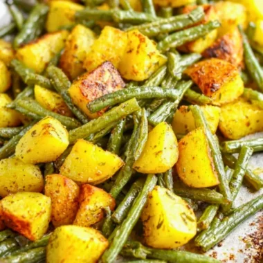 Delicious oven-roasted potatoes and green beans served on a plate