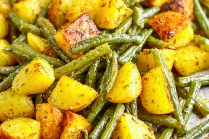 Delicious oven-roasted potatoes and green beans served on a plate