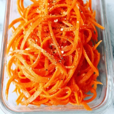 Fresh raw carrot salad with herbs and dressing