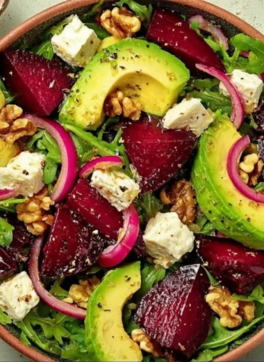 Roasted Beet Salad with Arugula, Feta, and Walnuts served in a bowl