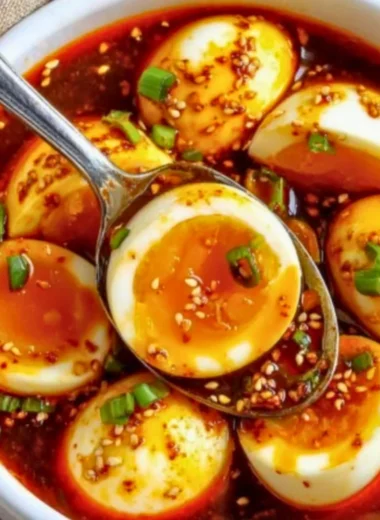 Spicy Gochujang Eggs served on a plate with fresh herbs