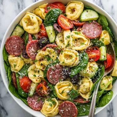 Colorful tortellini pasta salad with fresh vegetables and herbs