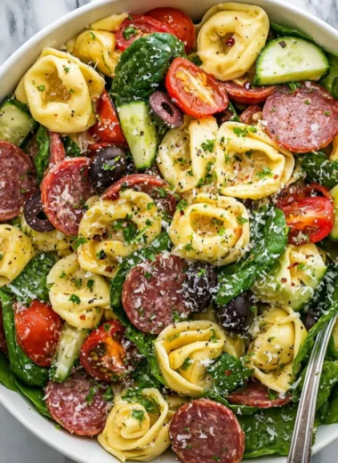 Colorful tortellini pasta salad with fresh vegetables and herbs
