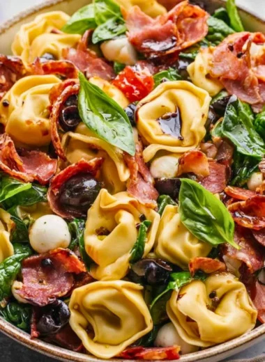 Delicious Tuscan Tortellini Salad with fresh vegetables and dressing.