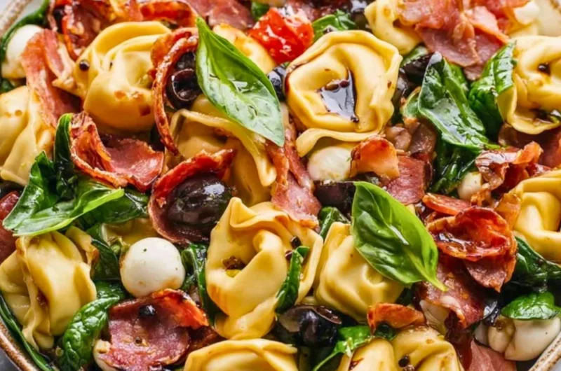 Delicious Tuscan Tortellini Salad with fresh vegetables and dressing.