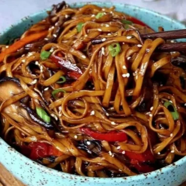 Colorful vegetable stir-fry noodles in a bowl, ready to serve for a healthy meal.