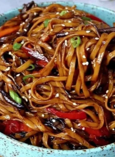 Colorful vegetable stir-fry noodles in a bowl, ready to serve for a healthy meal.