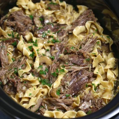 Crock pot beef and noodles dish served in a bowl, perfect for a family meal.