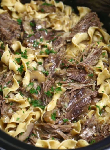 Crock pot beef and noodles dish served in a bowl, perfect for a family meal.