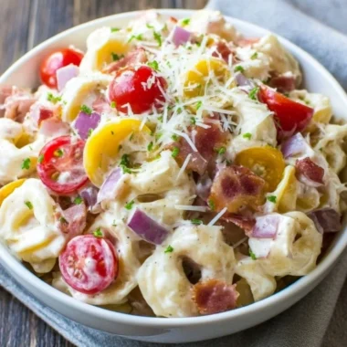 Colorful bowl of best grinder tortellini salad with fresh vegetables and dressing
