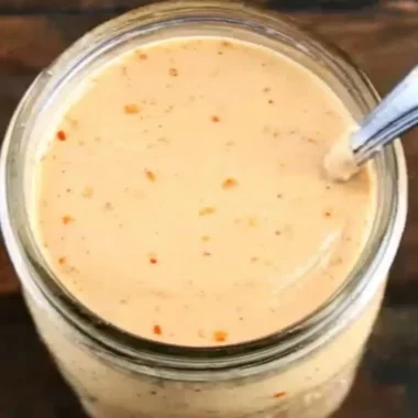 Bottle of Boom Sauce showcasing vibrant label and rich contents.