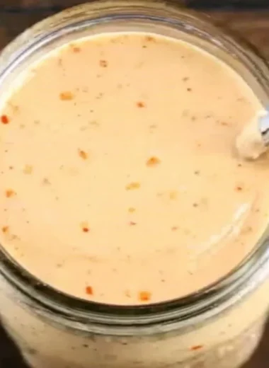 Bottle of Boom Sauce showcasing vibrant label and rich contents.