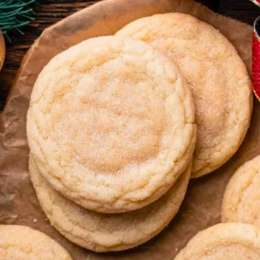 Chewy sugar cookies with a soft, golden texture and sprinkles on top.