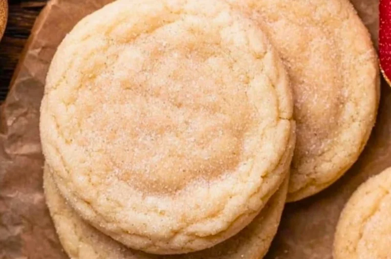 Chewy sugar cookies with a soft, golden texture and sprinkles on top.