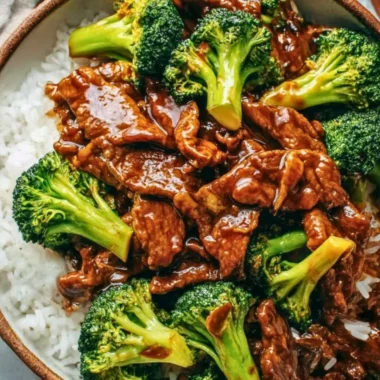 A plate of Chinese beef and broccoli stir-fry with vibrant vegetables