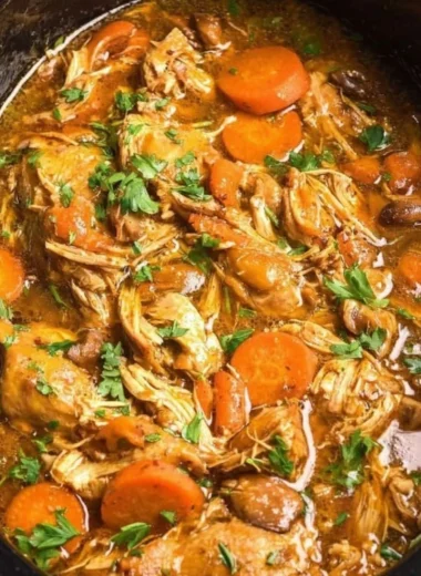 Crockpot chicken thigh pot roast served with vegetables and herbs