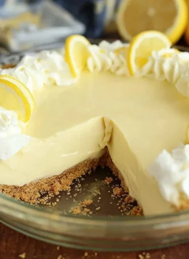 Slice of easy lemon cream pie on a plate with lemon slices