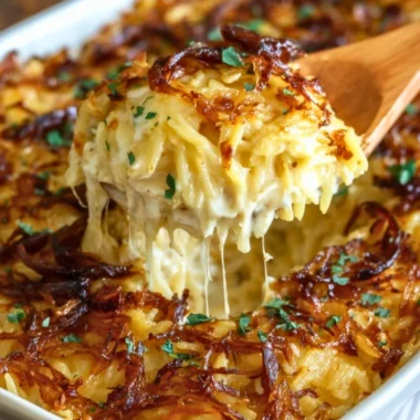 French Onion Chicken Orzo Casserole topped with cheese and herbs