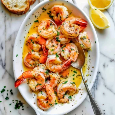 Plate of garlic butter shrimp scampi with fresh parsley and lemon