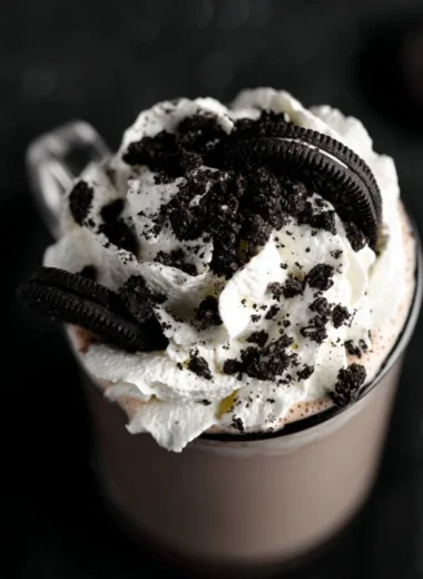 A delicious cup of creamy Oreo hot chocolate topped with whipped cream and cookie crumbles.