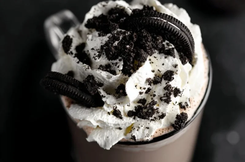 A delicious cup of creamy Oreo hot chocolate topped with whipped cream and cookie crumbles.