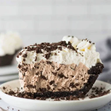 Delicious Oreo Pudding Pie topped with whipped cream and Oreo crumbles