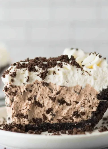 Delicious Oreo Pudding Pie topped with whipped cream and Oreo crumbles