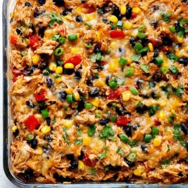 Delicious protein burrito casserole topped with cheese and fresh ingredients