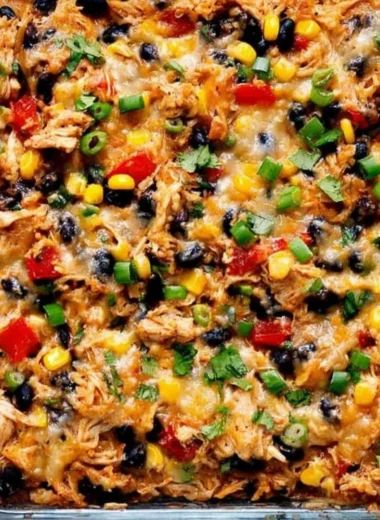 Delicious protein burrito casserole topped with cheese and fresh ingredients