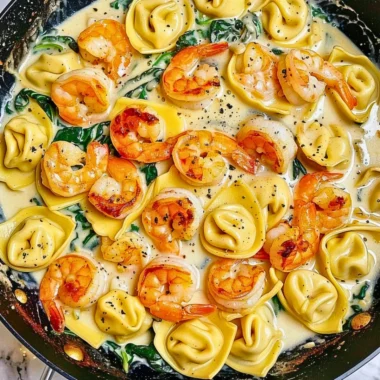 Delicious shrimp tortellini in garlic sauce with herbs and parmesan