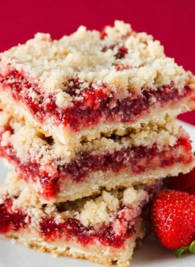 Delicious strawberry crumb bars topped with a golden crumb crust