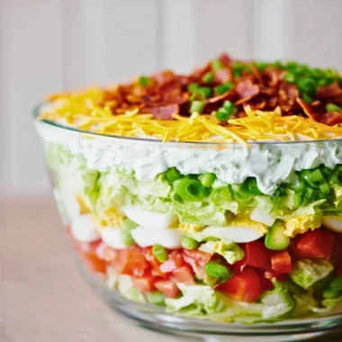 Delicious 7 Layer Salad featuring colorful veggies and layers of flavor.