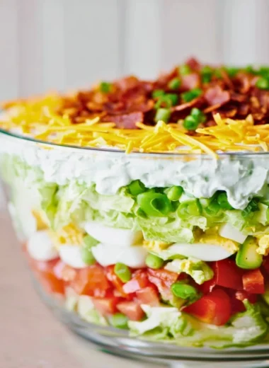 Delicious 7 Layer Salad featuring colorful veggies and layers of flavor.