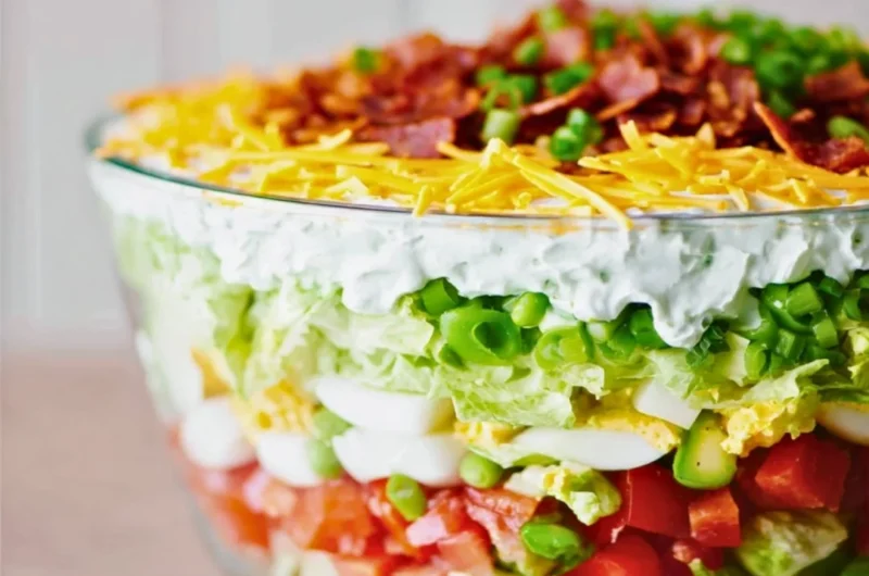 Delicious 7 Layer Salad featuring colorful veggies and layers of flavor.