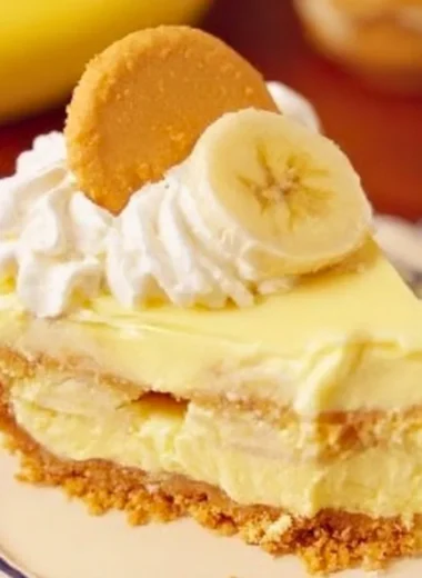 Delicious slice of banana pudding cheesecake with banana and vanilla topping