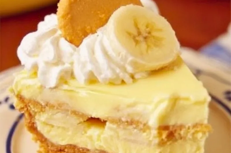 Delicious slice of banana pudding cheesecake with banana and vanilla topping