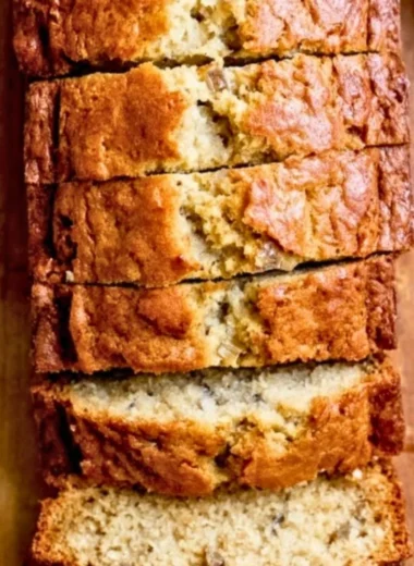 Delicious homemade banana bread sliced on a wooden cutting board