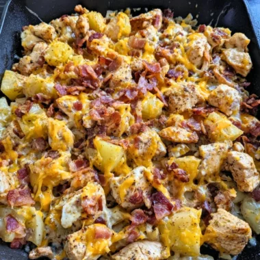 Delicious Blackstone Chicken Bacon Ranch Skillet with bacon and chicken pieces.